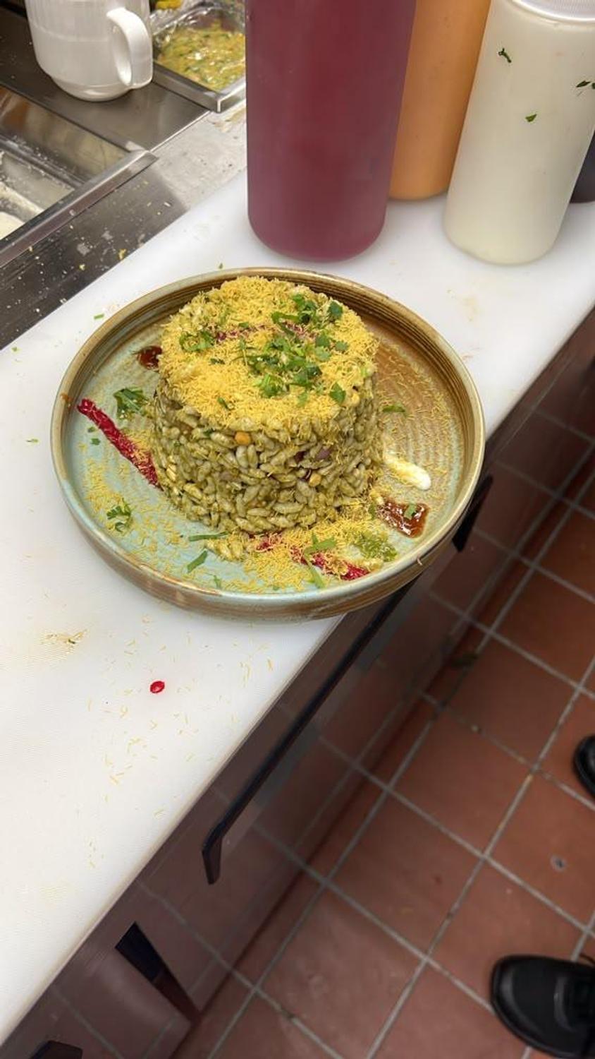 Bhel puri topped with sev and cilantro